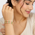 Gold-toned bangles with pink & green teardrop stones, set of 2 filigree design.