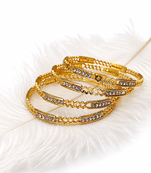 Gold-toned crystal studded bangles set of 4 for women rhinestone embellished, stackable design, ethnic wear.