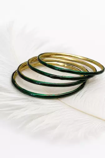 Gold-toned crystal studded bangles set of 4 for women rhinestone embellished, stackable design, zigzag chain pattern.