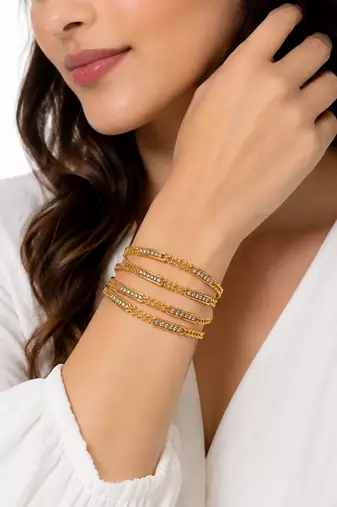 Gold-toned crystal studded bangles set of 4 for women rhinestone embellished, stackable design, ethnic wear.