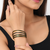 Gold-toned crystal studded bangles set of 4 for women rhinestone embellished, stackable design, zigzag chain pattern.