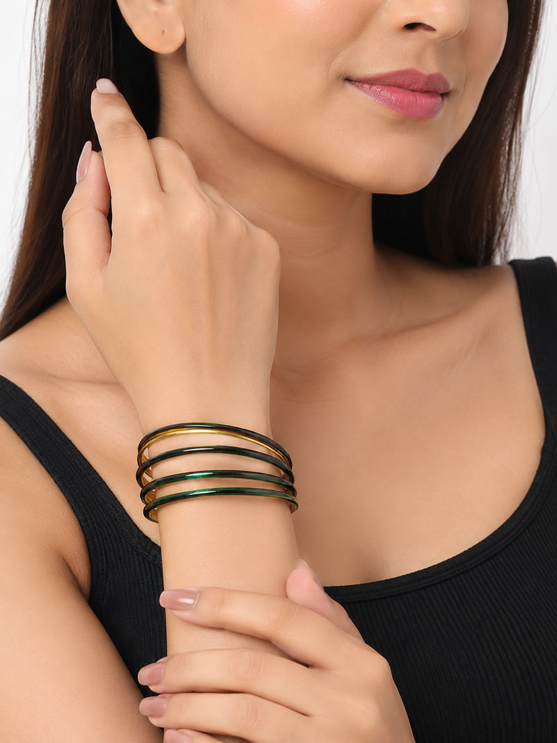 Gold-toned crystal studded bangles set of 4 for women rhinestone embellished, stackable design, zigzag chain pattern.