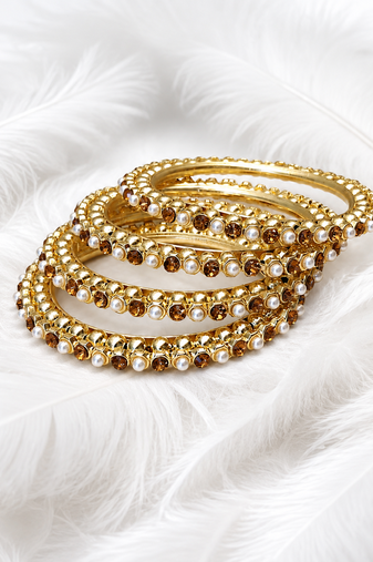 Gold-toned pearl and crystal studded bangles set amber crystal stones, faux pearl accents