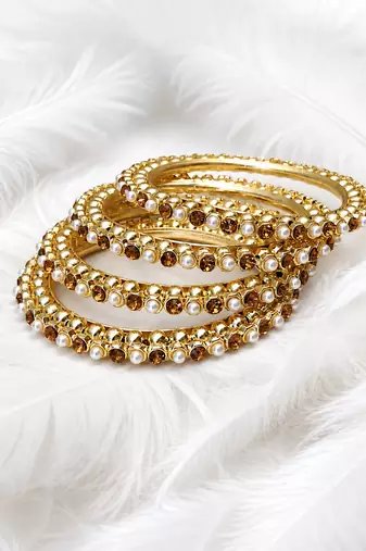 Gold-toned pearl and crystal studded bangles set amber crystal stones, faux pearl accents