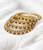Gold-toned pearl and crystal studded bangles set amber crystal stones, faux pearl accents