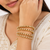 Gold-toned pearl and crystal studded bangles set amber crystal stones, faux pearl accents
