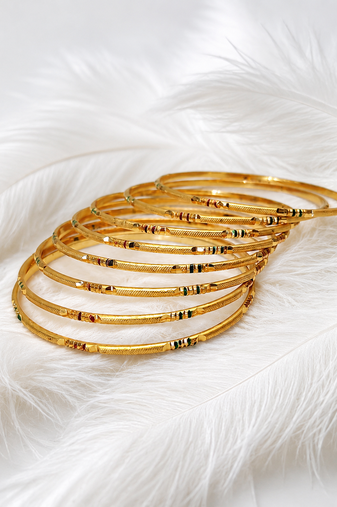 Gold-toned bangle set with enamel detail