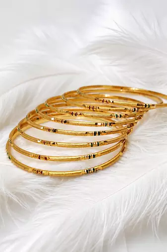 Gold-toned bangle set with enamel detail