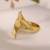 Curved gold tone statement ring