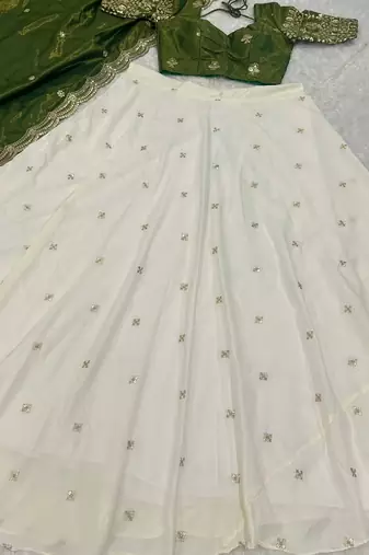 off white silk lehenga with green zari blouse