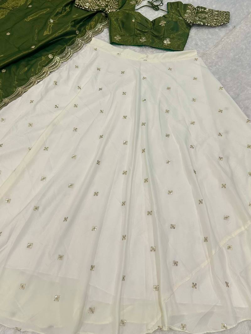 off white silk lehenga with green zari blouse