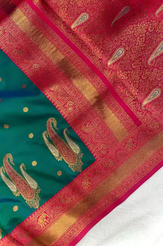 dark green color contrast weaving pallu and border kanchi weaving buttis on border silk blend saree