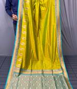 olive green color contrast weaving pallu and border kanchi weaving buttis on border silk blend saree