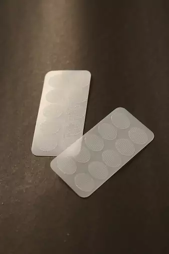 Invisible ear lobe support patches for heavy earring relief