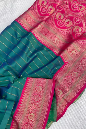 sea green color rich contrast weaving pallu and border kanchi weaving buttis on border silk blend saree