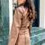 Women’s mid-length 70s-inspired leather duster coat in a burnished tan/light brown