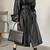 Women’s avant-garde longline black leather trench coat oversized silhouette