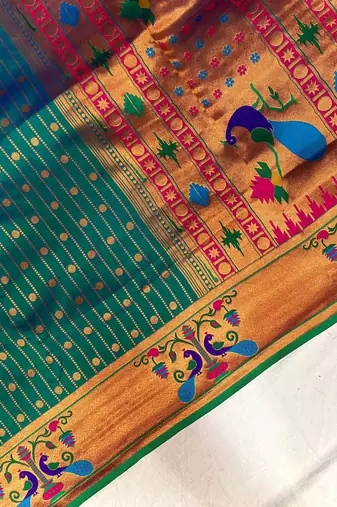 emerald green color rich weaved pallu along polka design zari silk blend saree