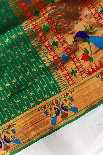 green color rich weaved pallu along polka design zari silk blend saree
