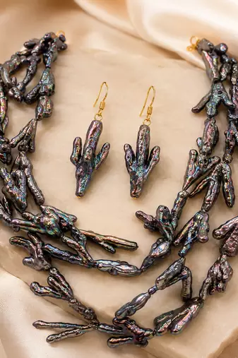 Baroque pearl necklace and earring set, dark iridescent multi-strand necklace, cactus-shaped earrings.