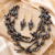Baroque pearl necklace and earring set, dark iridescent multi-strand necklace, cactus-shaped earrings.