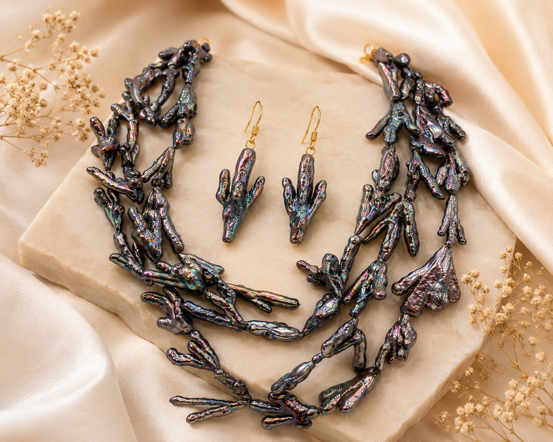 Baroque pearl necklace and earring set, dark iridescent multi-strand necklace, cactus-shaped earrings.
