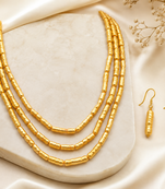 Gold-toned 3-layer beaded necklace and earrings jewellery set cylindrical beads.