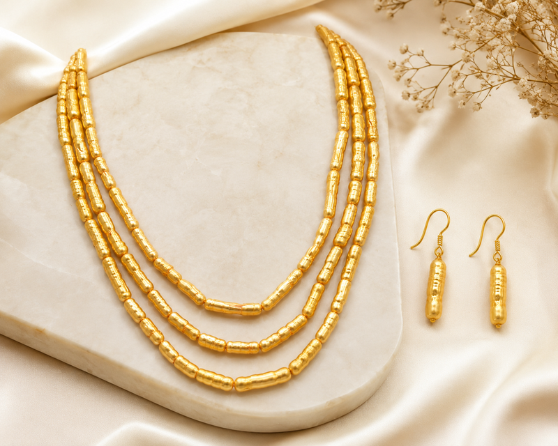 Gold-toned 3-layer beaded necklace and earrings jewellery set cylindrical beads.