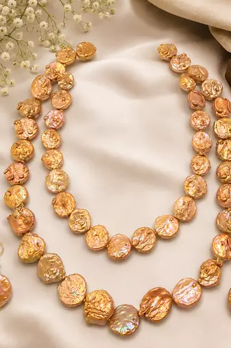 Freshwater coin pearl necklace set with earrings, peach gold double strand, baroque texture, iridescent lustre.