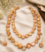 Freshwater coin pearl necklace set with earrings, peach gold double strand, baroque texture, iridescent lustre.