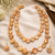 Freshwater coin pearl necklace set with earrings, peach gold double strand, baroque texture, iridescent lustre.