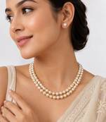 Double strand pearl necklace set with gold rondelle spacers includes stud earrings, layered design.