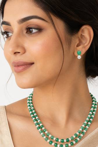 Double strand green beads and pearl necklace set with earrings.