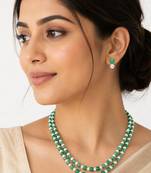 Double strand green beads and pearl necklace set with earrings.