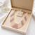 Multi-strand pearl necklace set with stud earrings, multicolour 7 layers, white & mauve tones, freshwater.