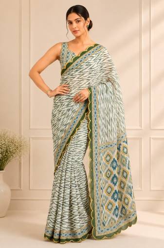 white heavy silk blend mirror work saree
