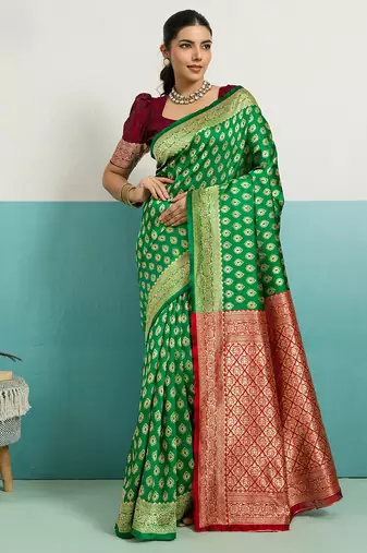 green banarasi silk blend zari woven with jaal saree with blouse