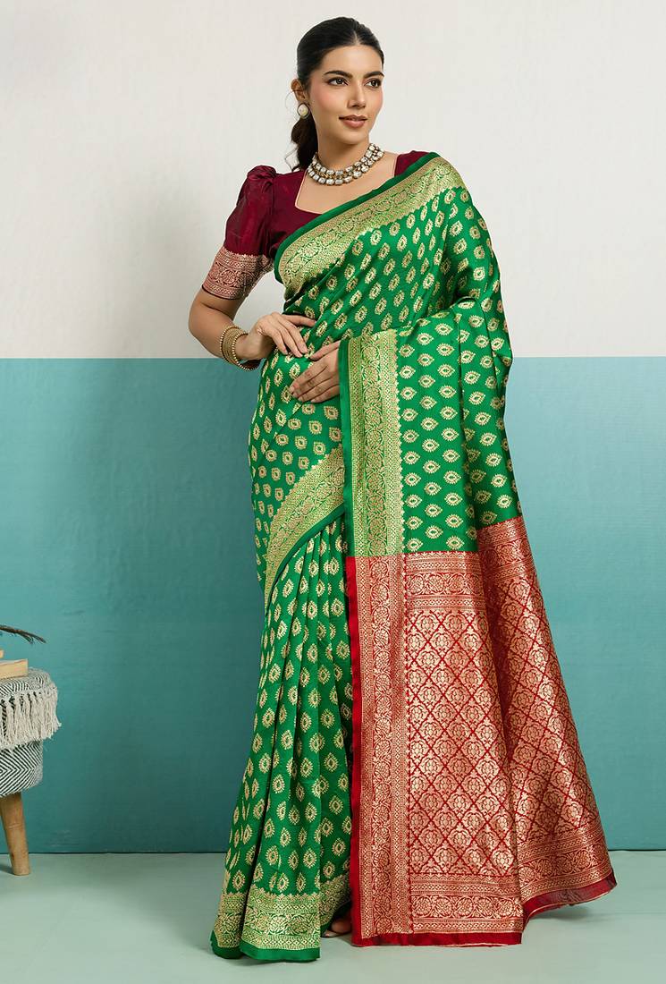 green banarasi silk blend zari woven with jaal saree with blouse