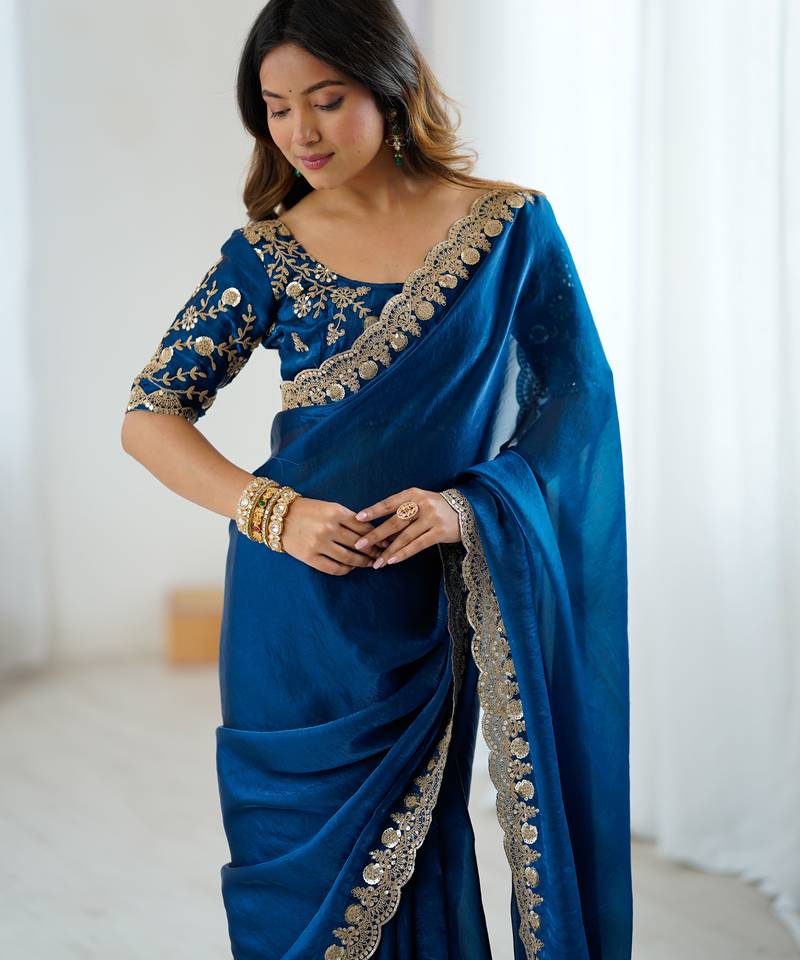 Blue tissue satin embrloidered saree with unstitched blouse piece.