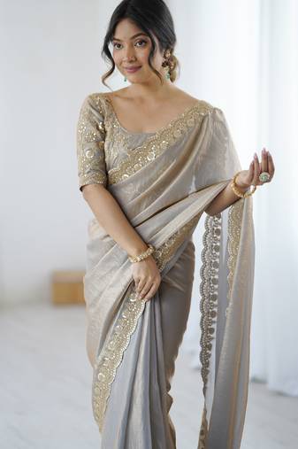 Grey tissue satin embrloidered saree with unstitched blouse piece.