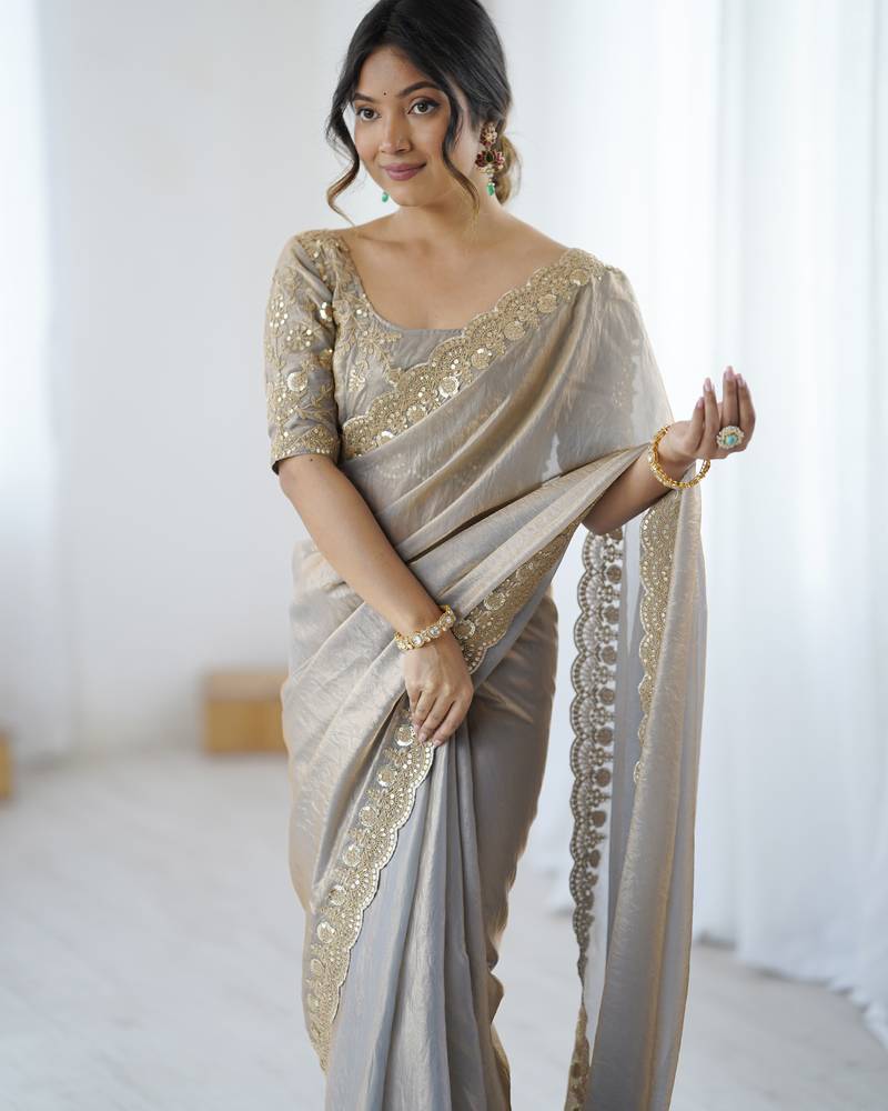 Grey tissue satin embrloidered saree with unstitched blouse piece.
