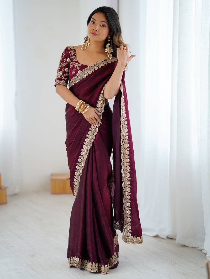 Wine tissue satin embrloidered saree with unstitched blouse piece.