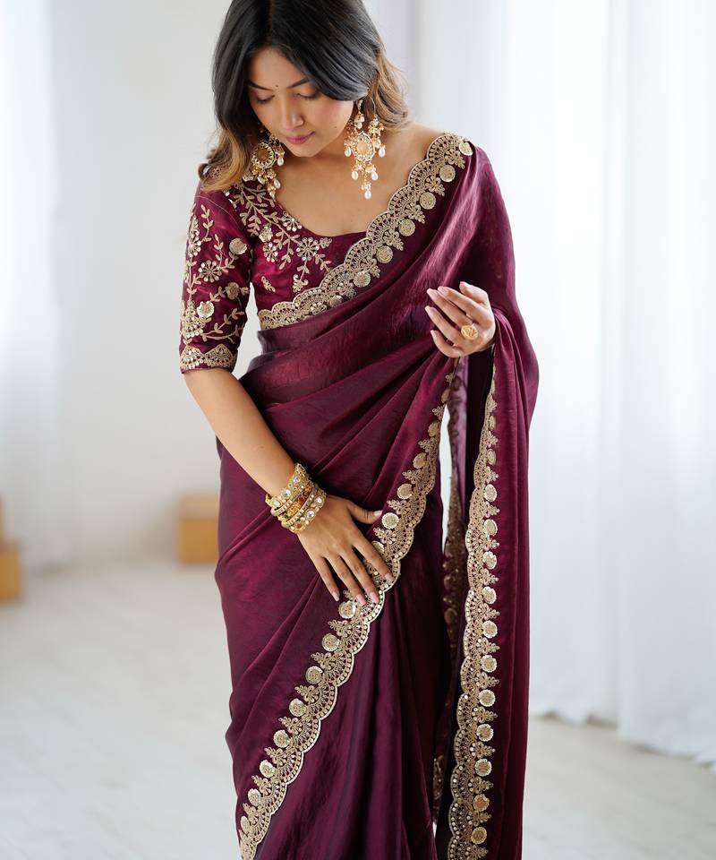 Wine tissue satin embrloidered saree with unstitched blouse piece.