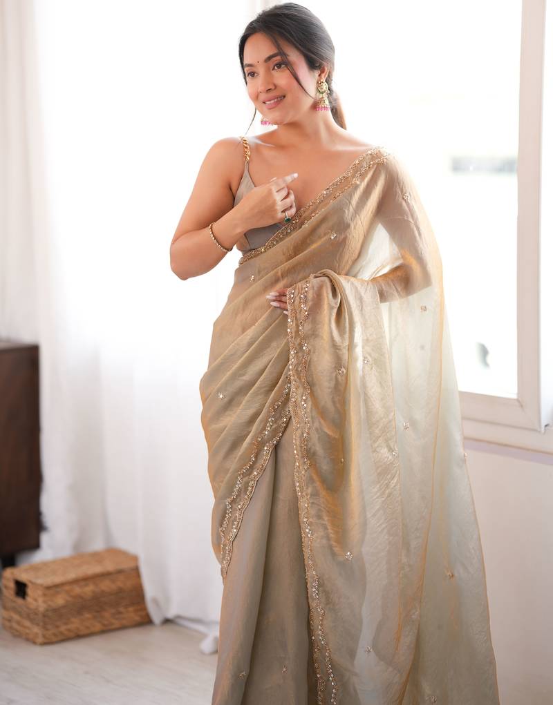 Beige tissue satin sequins saree with unstitched blouse piece.
