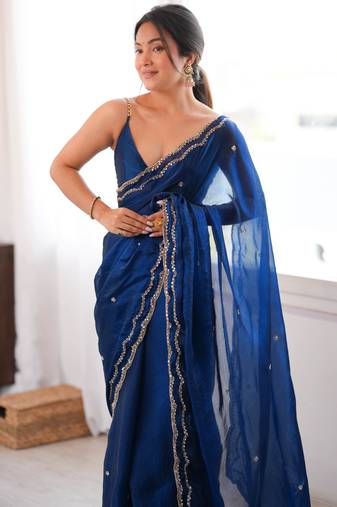 Blue tissue satin sequins saree with unstitched blouse piece.