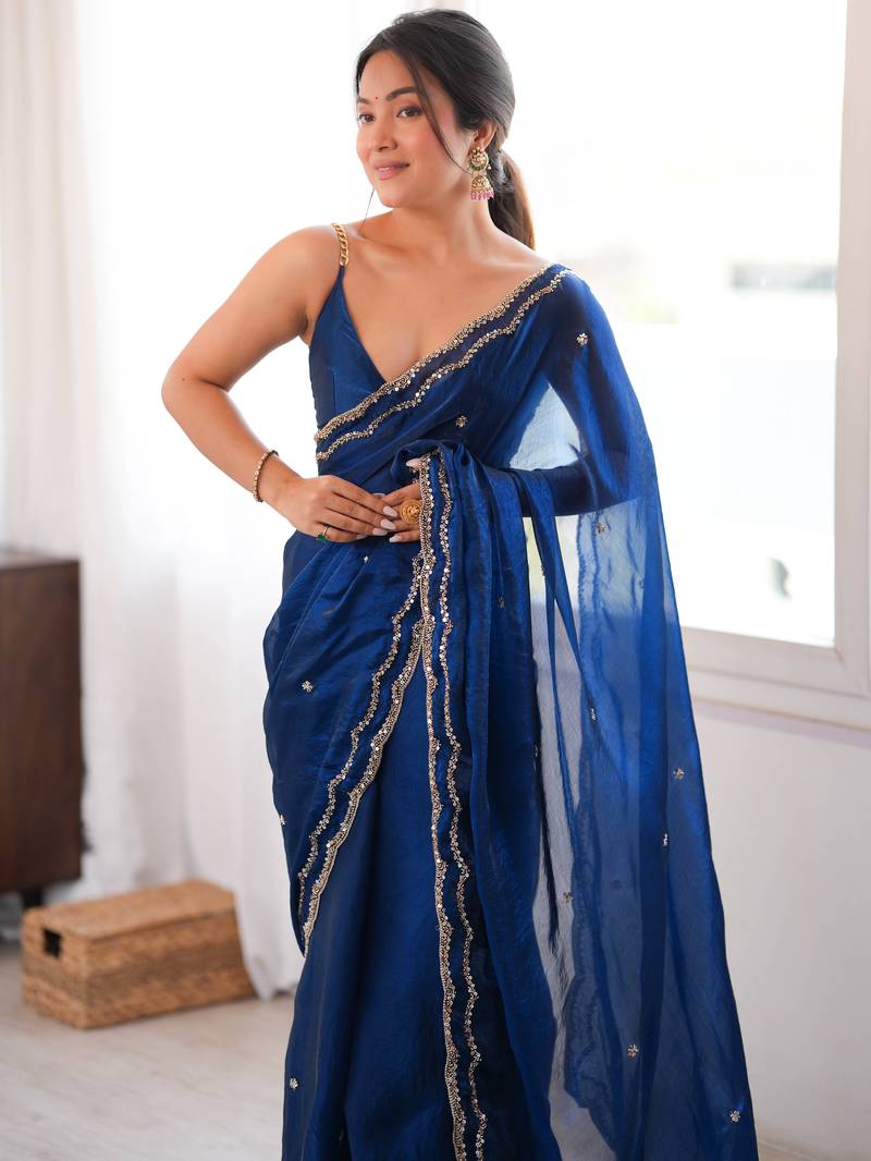 Blue tissue satin sequins saree with unstitched blouse piece.