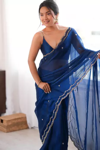 Blue tissue satin sequins saree with unstitched blouse piece.
