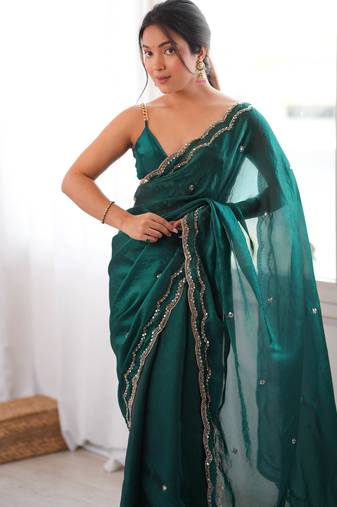 Bottle green tissue satin sequins saree with unstitched blouse piece.