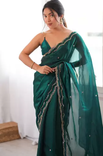 Bottle green tissue satin sequins saree with unstitched blouse piece.