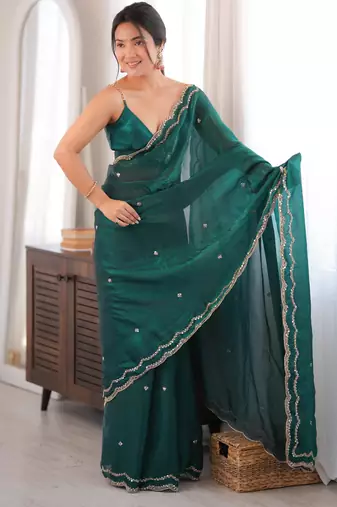 Bottle green tissue satin sequins saree with unstitched blouse piece.